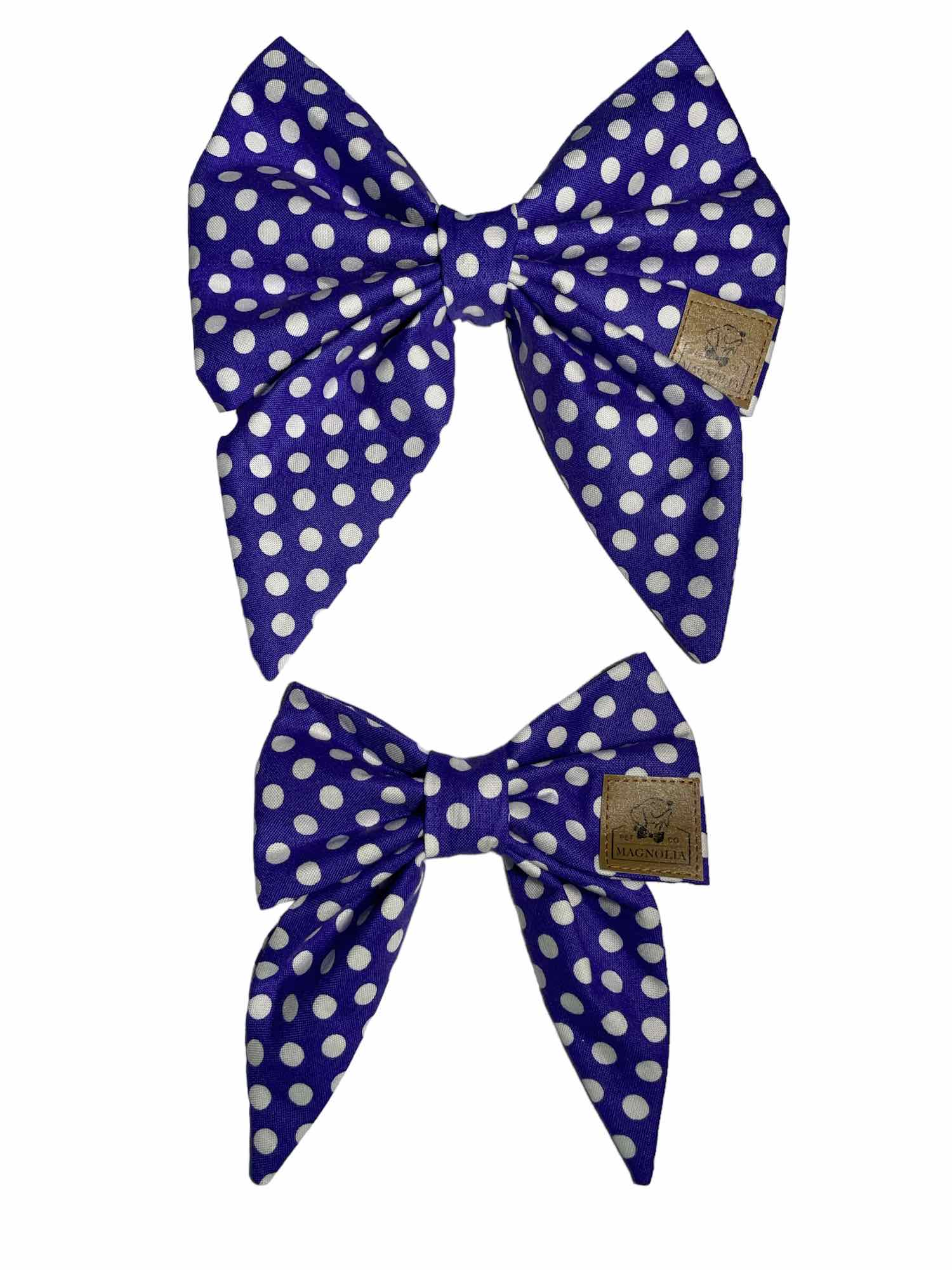 This enchanting bow features a deep purple background adorned with classic white polka dots, creating a timeless and playful design that suits any occasion