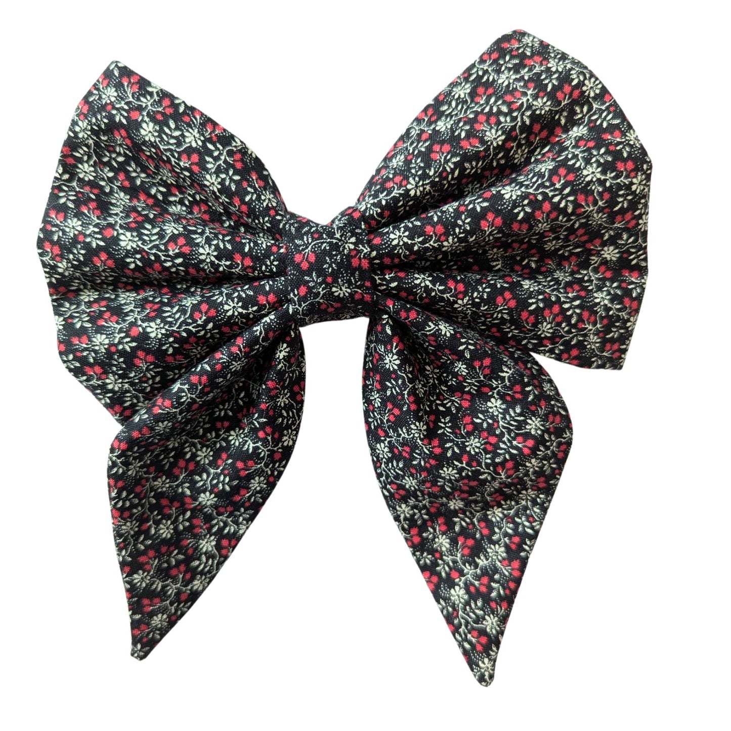 bow features a delicate pattern of small red and white flowers on a black fabric background