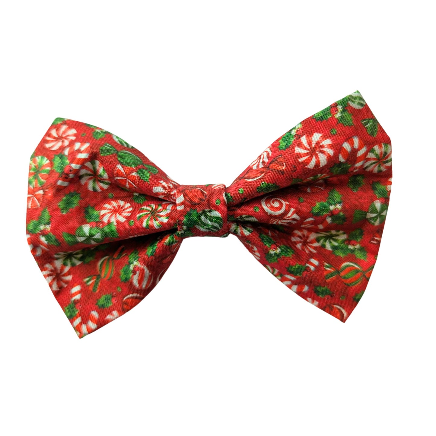 vibrant red fabric adorned with classic peppermint candies and tiny holly leaves