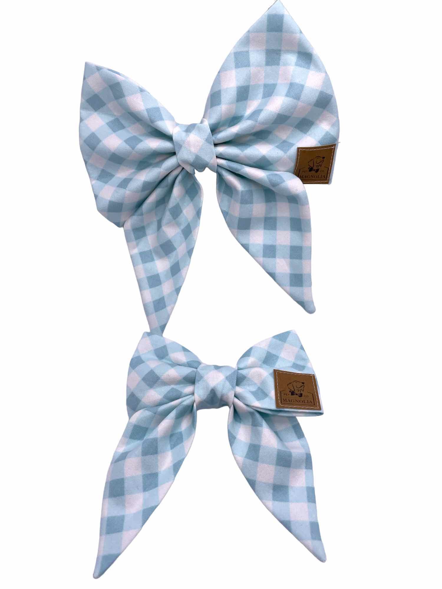 This delightful accessory features a timeless light blue gingham check pattern