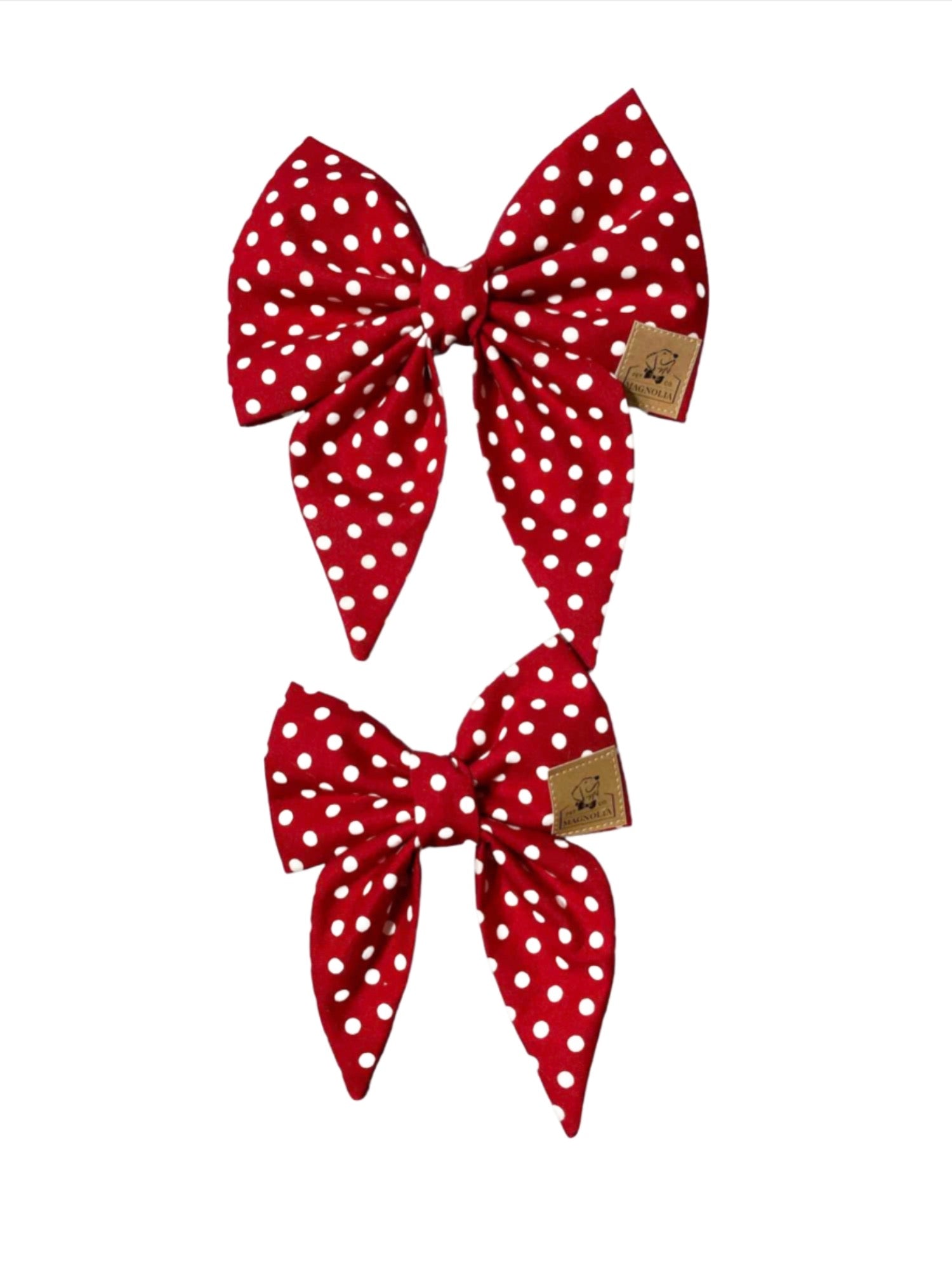 Crafted from vibrant red fabric adorned with playful white polka dots, this delightful bow is the perfect blend of whimsy and elegance.